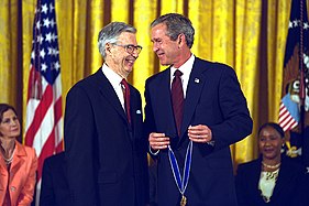 Fred Rogers smiles as he receives the award from President George W. Bush, 2002