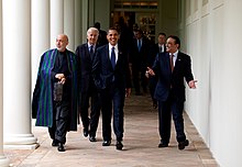 Photo of Obama and other heads of state walking along the Colonnade outside the White House
