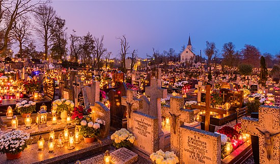 Holy Cross Cemetery in Gniezno on 1 November, with each grave decorated with flowers and several lit candles