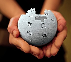 A 3D-printed Wikipedia globe being held in someone's hands