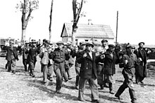 Men rounded up and walking