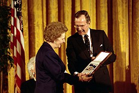 Former United Kingdom Prime Minister Margaret Thatcher receiving the award, in its unusual bow form, from President George H. W. Bush, 1991