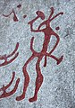 Nordic Bronze Age petroglyph featuring a figure holding a hammer-like object among the Tanum rock carvings, Sweden