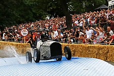 A participant driving through the course for the Red Bull Soapbox Race held in Alexandra Palace, London in 2017.