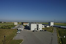 The Virgo site with, in the foreground, the building which hosts the detector control room and the local computer center.