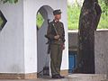 一名北韓士兵正於北韓非軍事區共同警備處的道路旁站崗，攝於2005年。
