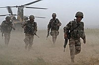 DBDU-clad Spanish soldiers disembark from a CH-47 Chinook helicopter in Afghanistan, September 2008