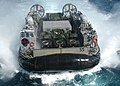 A US Navy LCAC maneuvers to enter the well deck of the amphibious assault ship USS Kearsarge