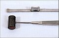 Rhinoplastic instruments: An osteotome (bone chisel) and a surgical hammer for sculpting craniofacial bones.
