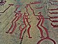 Nordic Bronze Age petroglyph featuring figures holding hammers or axe-like objects among the Tanum rock carvings, Sweden