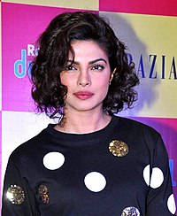 Priyanka Chopra, with short, curly hair, in a polka-dot top