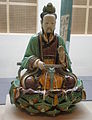 Statue de Bouddha assis, en céramique à glaçures verte et jaune, d'époque Ming