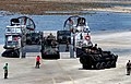 USMC LAV-25s and HMMWVs are offloaded from a USN LCAC craft at Samesan RTMB, Thailand