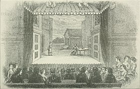 interior of old theatre, looking at the stage over the heads of a full audience