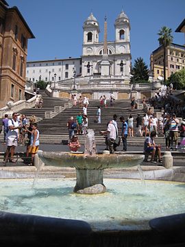 The Spanish Steps, seen from Piazza di Spagna. In the foreground is the Fontana della Barcaccia.