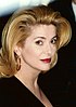 Catherine Deneuve t the 1995 Cannes Film Festival with blonde hair and facing to the left