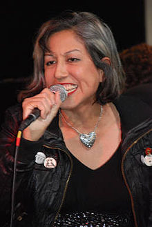 Alice Bag speaking into a microphone