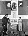 Party flag of Kuomintang adjacent to the portrait of founding President Sun Yat-sen was replaced by Flag of the Republic of China, marking to end of one-party rule