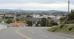 Looking across the Clutha towards the town centre. The distinctive road bridge is visible in the centre of the picture