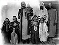 Abraham b. Abraham Yitzhak Halevi holding child in one arm, and holding walking cane, Sana'a Yemen, ca. 1940