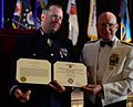 Adm. Robert J. Papp Jr. (right), commandant of the U.S. Coast Guard, presents a Coast Guard auxiliarist with the Coast Guard Auxiliary Commendation Medal in 2013.