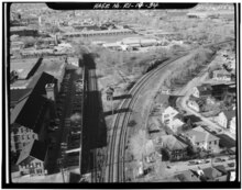 Aerial photo of a railroad junction; two tracks curve off to the right, while one track splits to the left. The left track becomes two tracks shortly after the junction.