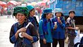Hani ladies eating ice cream in Laomeng village during market day